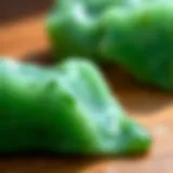 Close-up of a vibrant green jade crystal showcasing its rich color and texture.