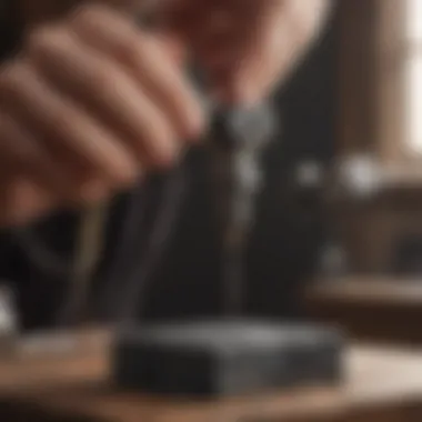 A jeweller demonstrating the use of a hand drill on a gemstone.