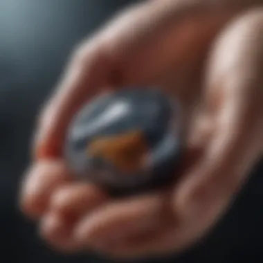 A close-up of a hand holding a healing stone, illustrating the personal connection to its energies.