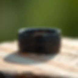 Elegant black titanium wedding band with intricate engraving